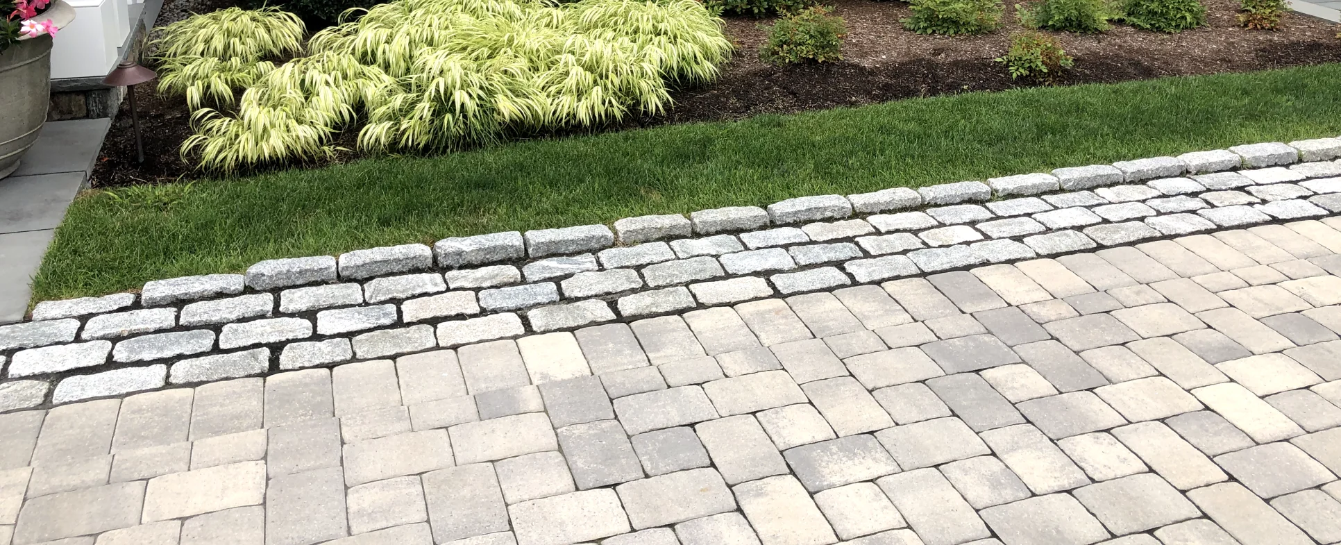 plantings by stone work driveway